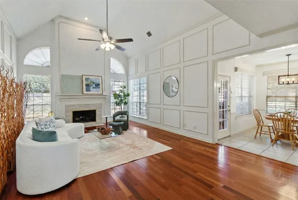 a living room with furniture a fireplace and a large window