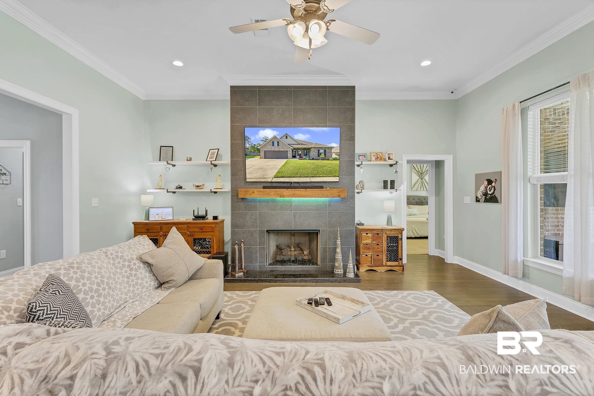 30635 Drayton Court Daphne, AL 36527 - Photo 15 of 51 Living area featuring a tile fireplace, wood finished floors, a ceiling fan, recessed lighting, and crown molding
