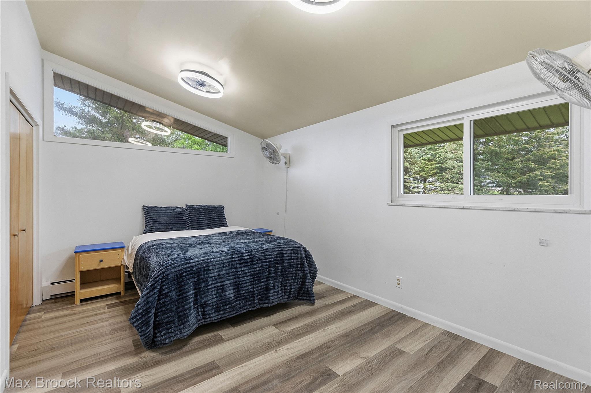 1392 Maple Grove Road Lapeer, MI 48446 - Photo 27 of 70 Bedroom with light wood-style flooring, lofted ceiling, and baseboard heating