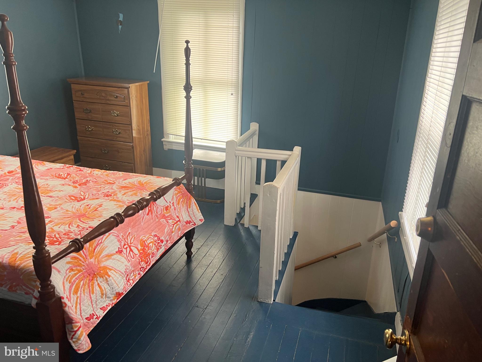 10 Willis Street Cambridge, MD 21613 - Photo 17 of 27 Charming bedroom with a cozy staircase.