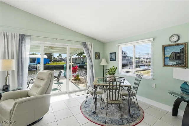 a living room with furniture potted plant and a flat screen tv