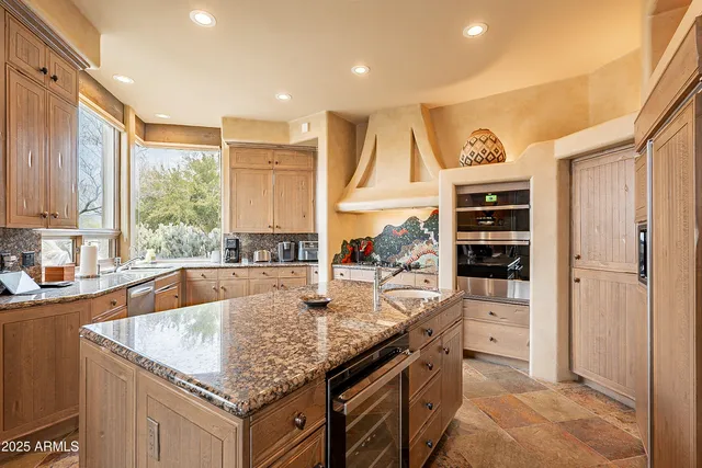 a living room with furniture a large window and a couch