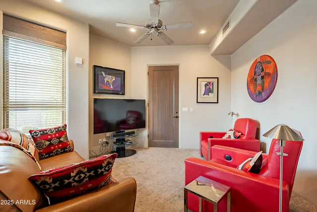 a bedroom with a bed and a potted plant