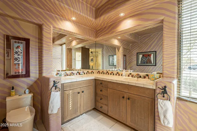 a bedroom with a bed mirror and a large window