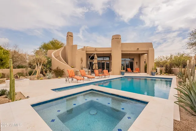 a bedroom with a bed a mirror and a large window