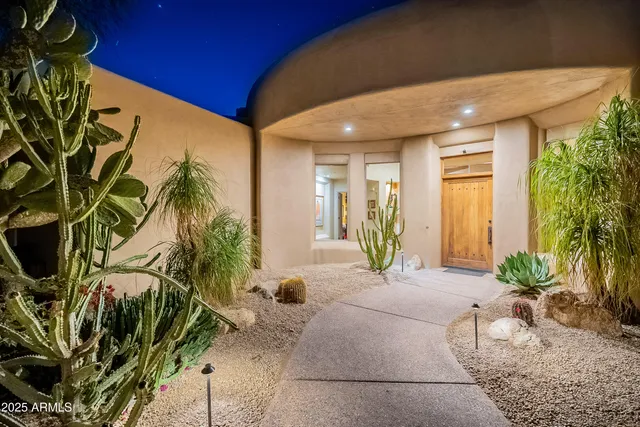 a living room with furniture a rug and a chandelier