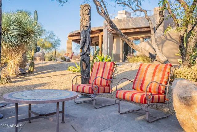a building outdoor space with patio furniture and potted plants