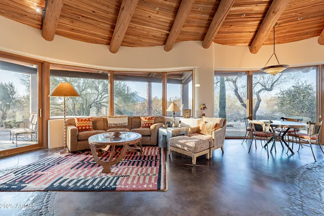 a backyard of a house with table and chairs
