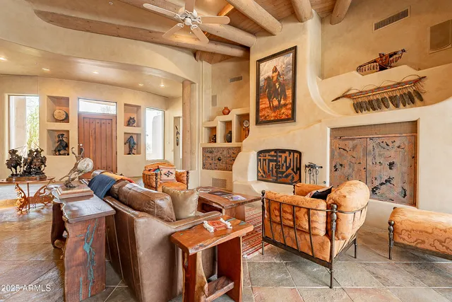 a dining room with furniture a floor to ceiling window and a chandelier