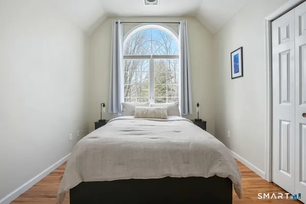 a bedroom with a bed and a closet