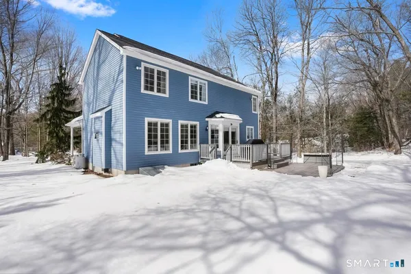 a view of a house with a snow in the yard