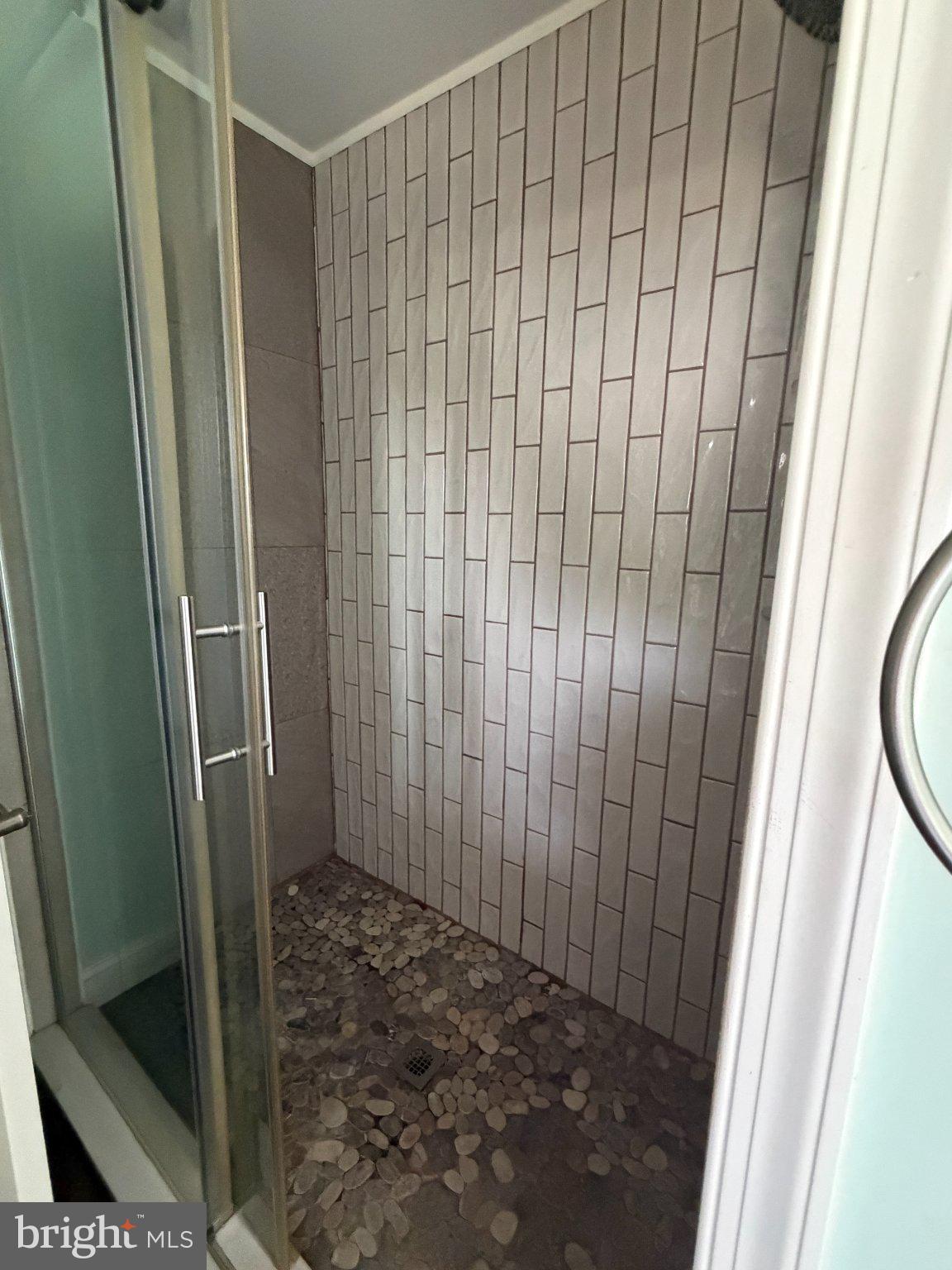 18658 Cool Spring Road Milton, DE 19968 - Photo 15 of 24 Modern shower with elegant tile design.