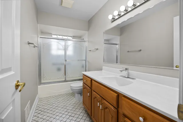 a bathroom with a sink a toilet a shower and a mirror