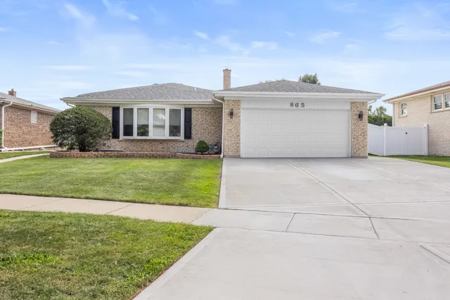 a view of a house with a yard and garage
