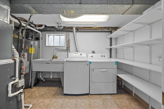 a utility room with cabinets washer and dryer