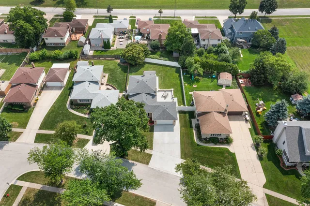 an aerial view of multiple houses with yard