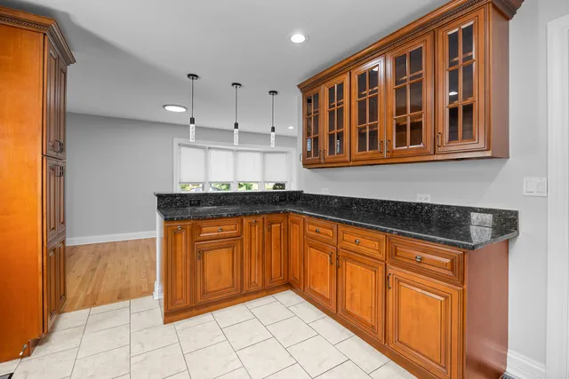 a kitchen with stainless steel appliances granite countertop a refrigerator and cabinets