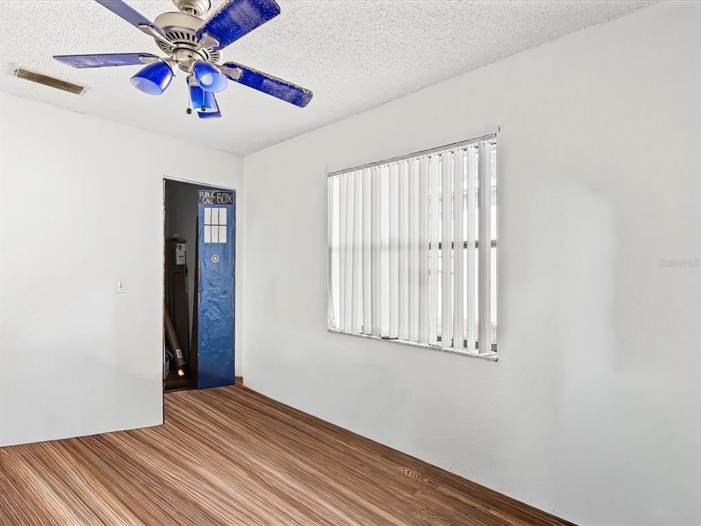 18824 Parade Road Hudson, FL 34667 - Photo 14 of 38 an empty room with windows and fan