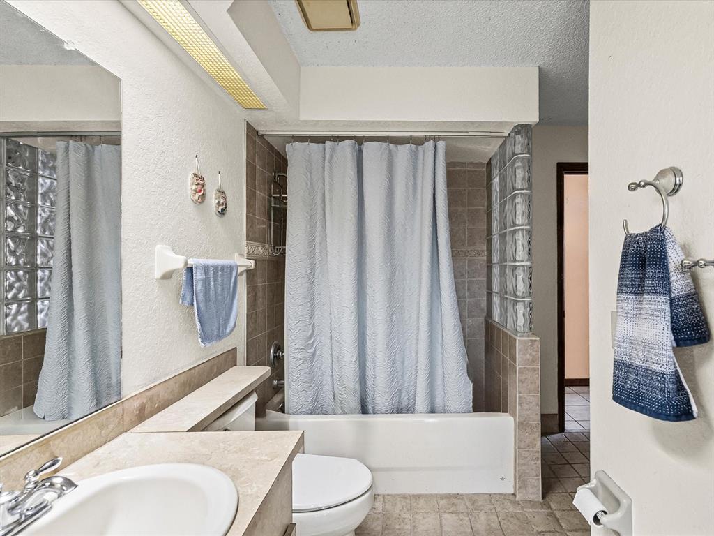 18824 Parade Road Hudson, FL 34667 - Photo 16 of 38 a bathroom with a sink toilet and shower