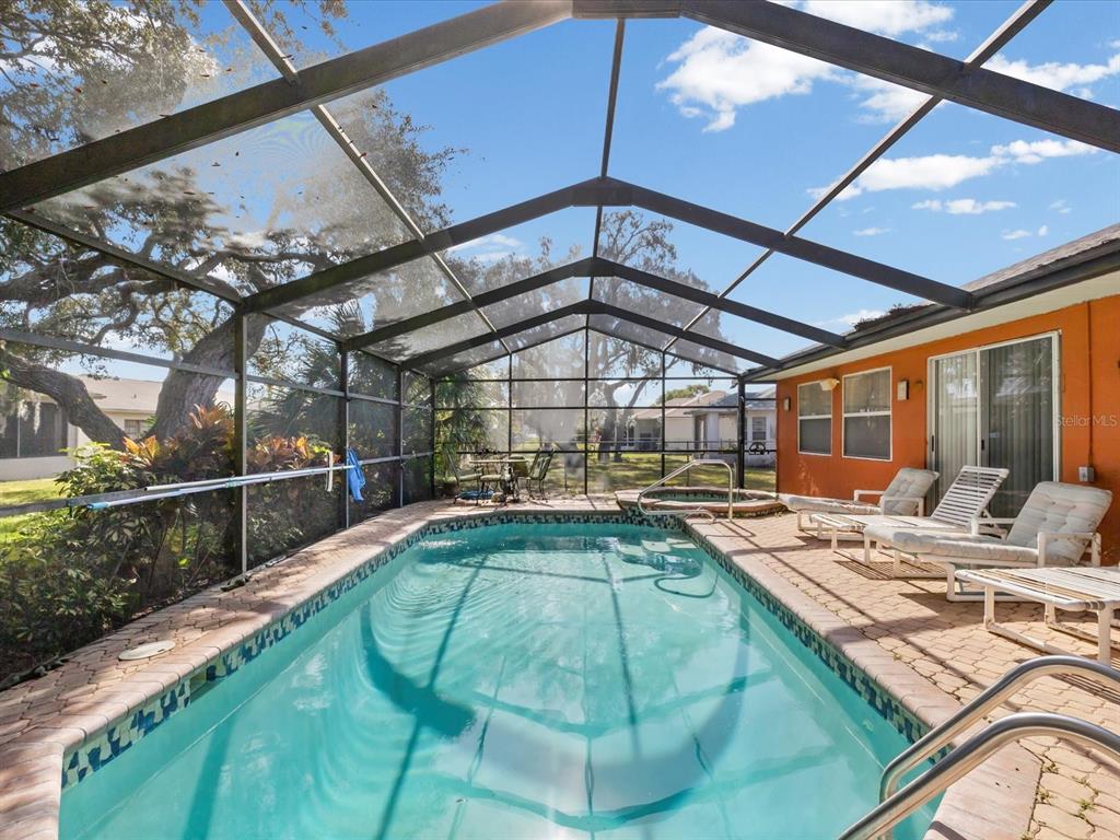 18824 Parade Road Hudson, FL 34667 - Photo 18 of 29 a view of a swimming pool with a patio