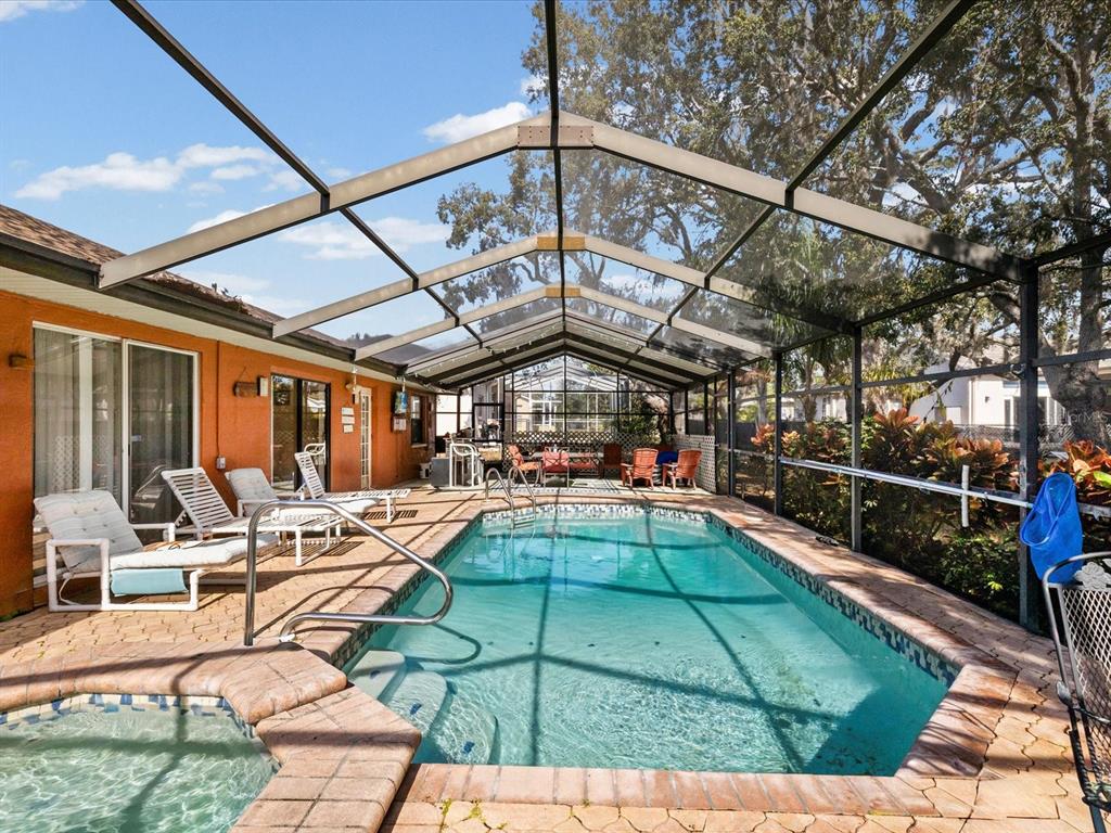 18824 Parade Road Hudson, FL 34667 - Photo 2 of 29 a view of a swimming pool with a patio