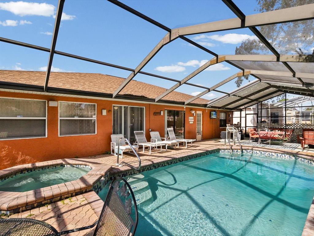 18824 Parade Road Hudson, FL 34667 - Photo 21 of 38 a outdoor living space with furniture and a fireplace