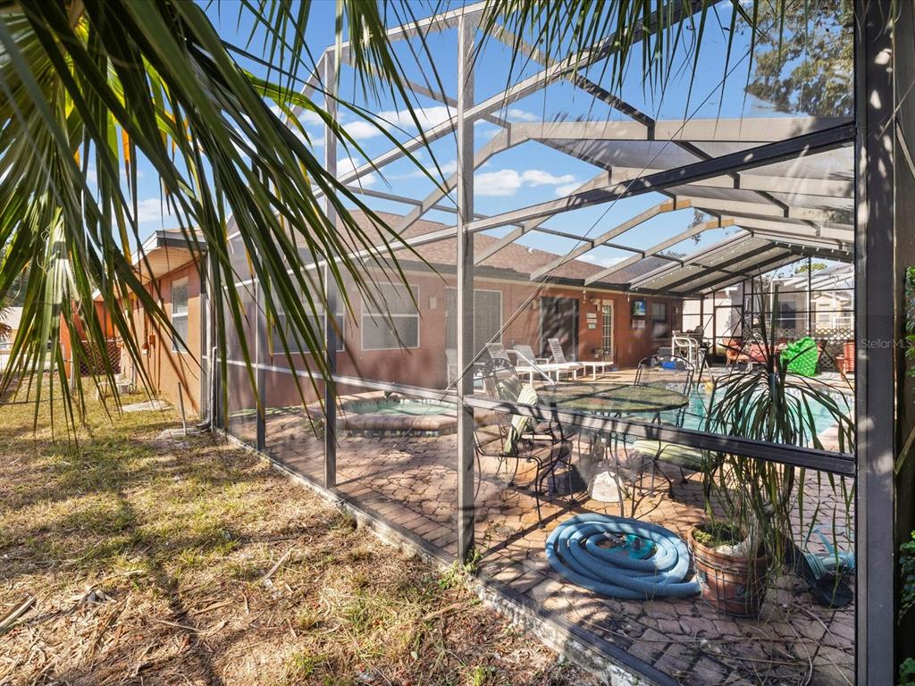 18824 Parade Road Hudson, FL 34667 - Photo 23 of 38 a view of a chairs and table in backyard