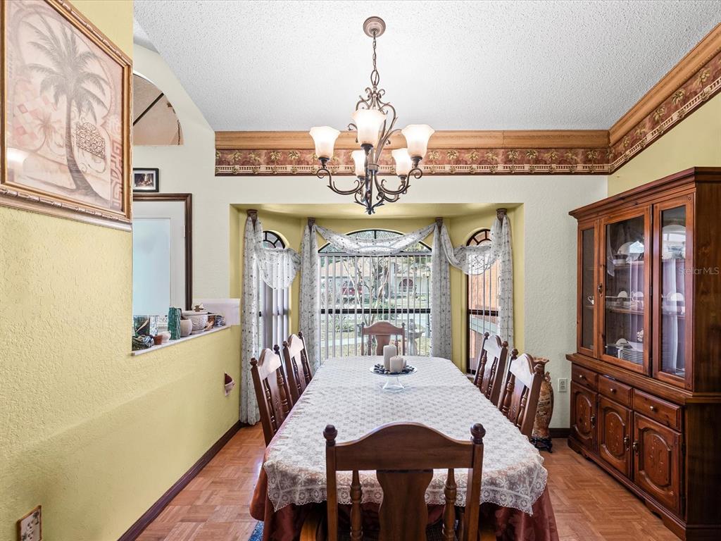 18824 Parade Road Hudson, FL 34667 - Photo 5 of 38 a view of a dining room with furniture window and wooden floor