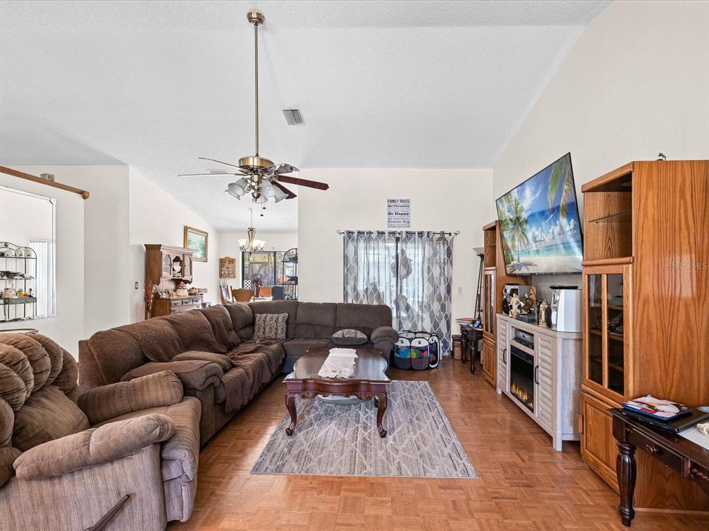 18824 Parade Road Hudson, FL 34667 - Photo 6 of 29 a living room with furniture fireplace and flat screen tv