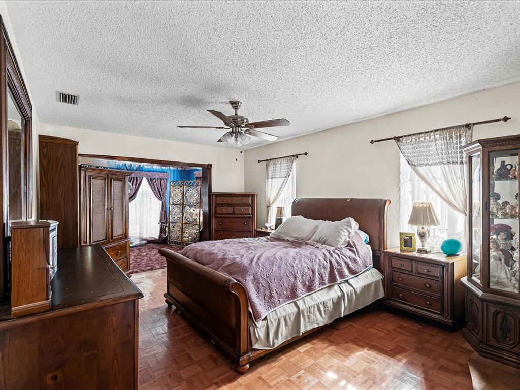 18824 Parade Road Hudson, FL 34667 - Photo 9 of 29 a bedroom with a large bed and a chandelier