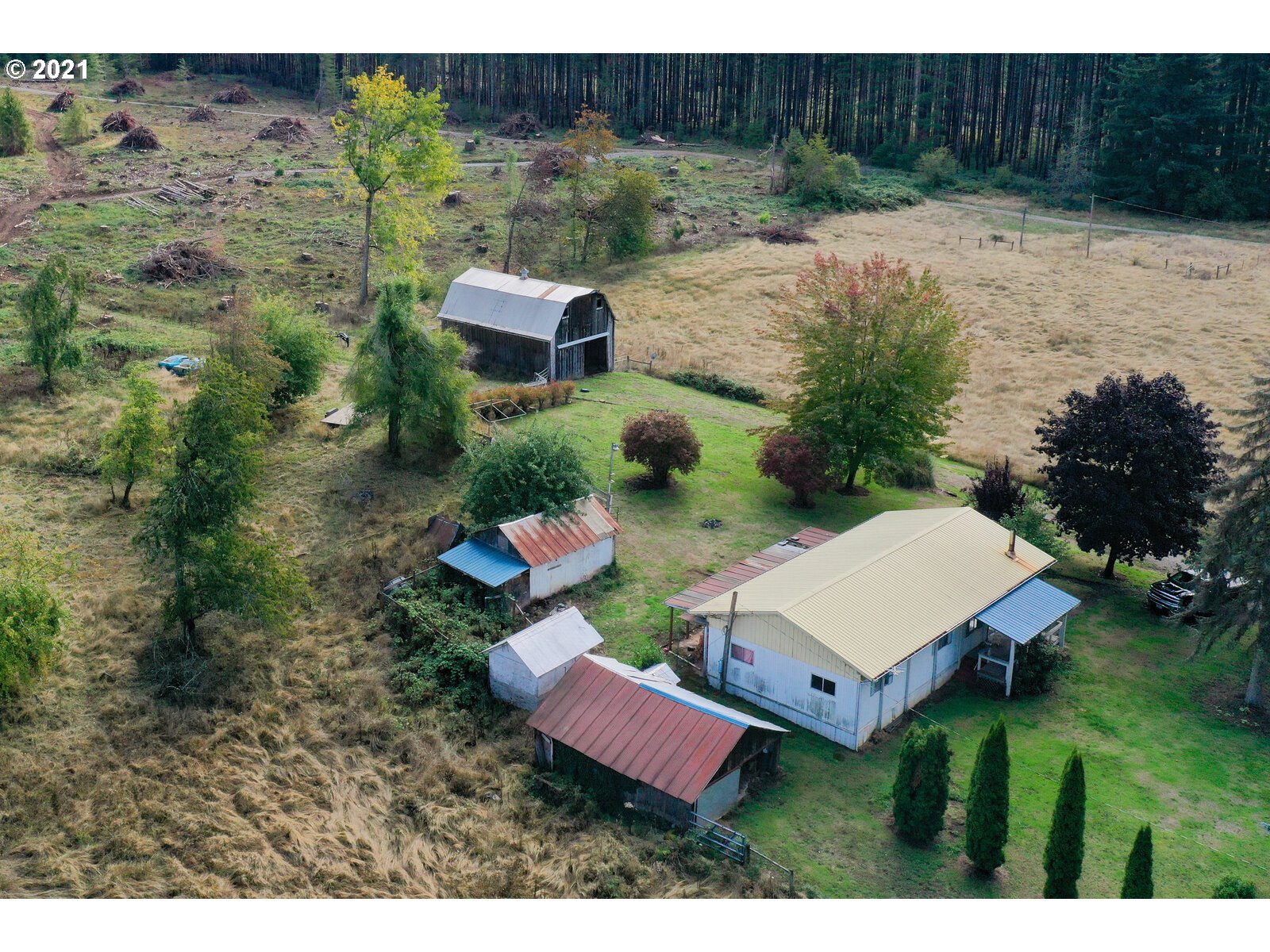 a view of a house with pool and a yard