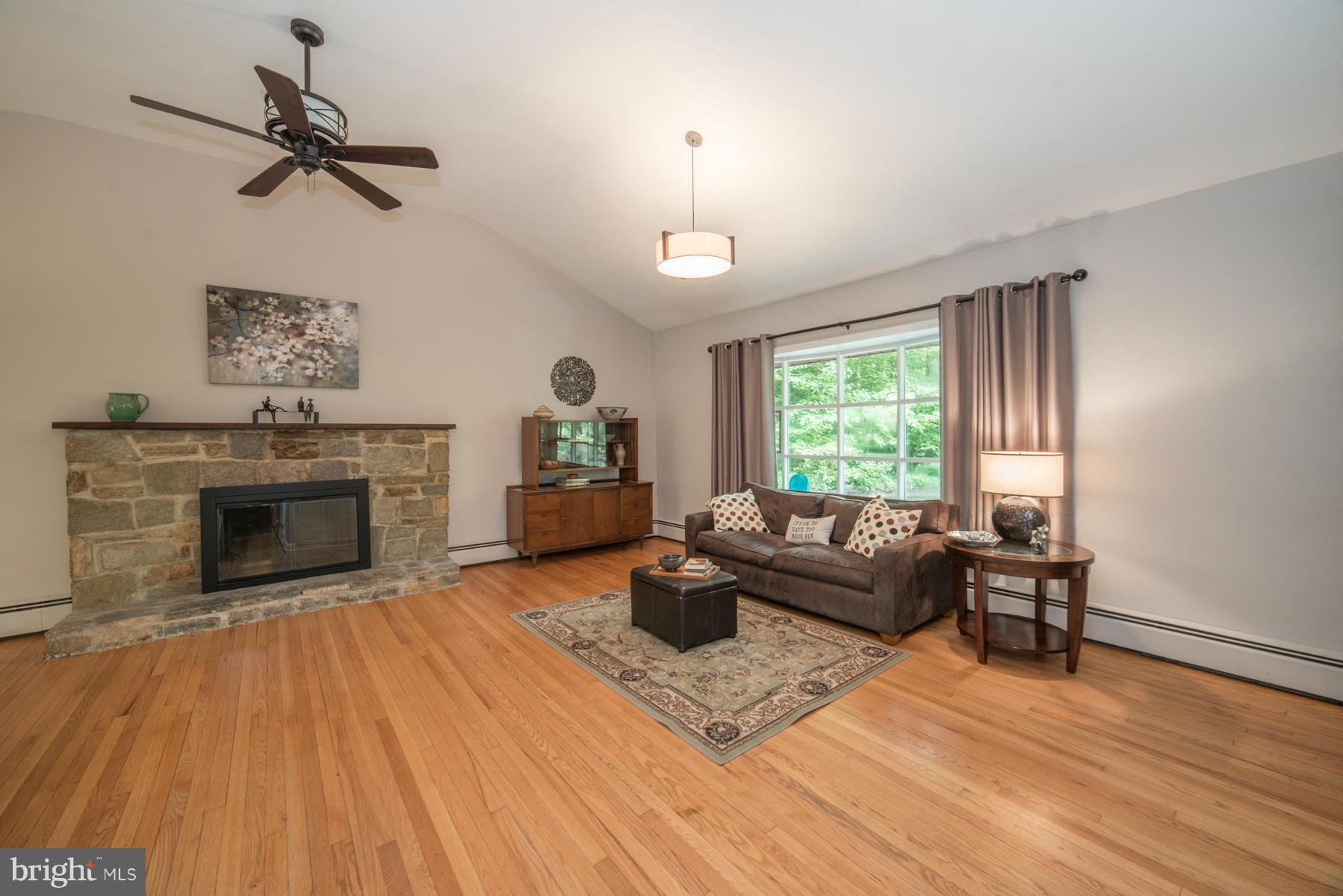 Living Room with hardwood floors and wood FP