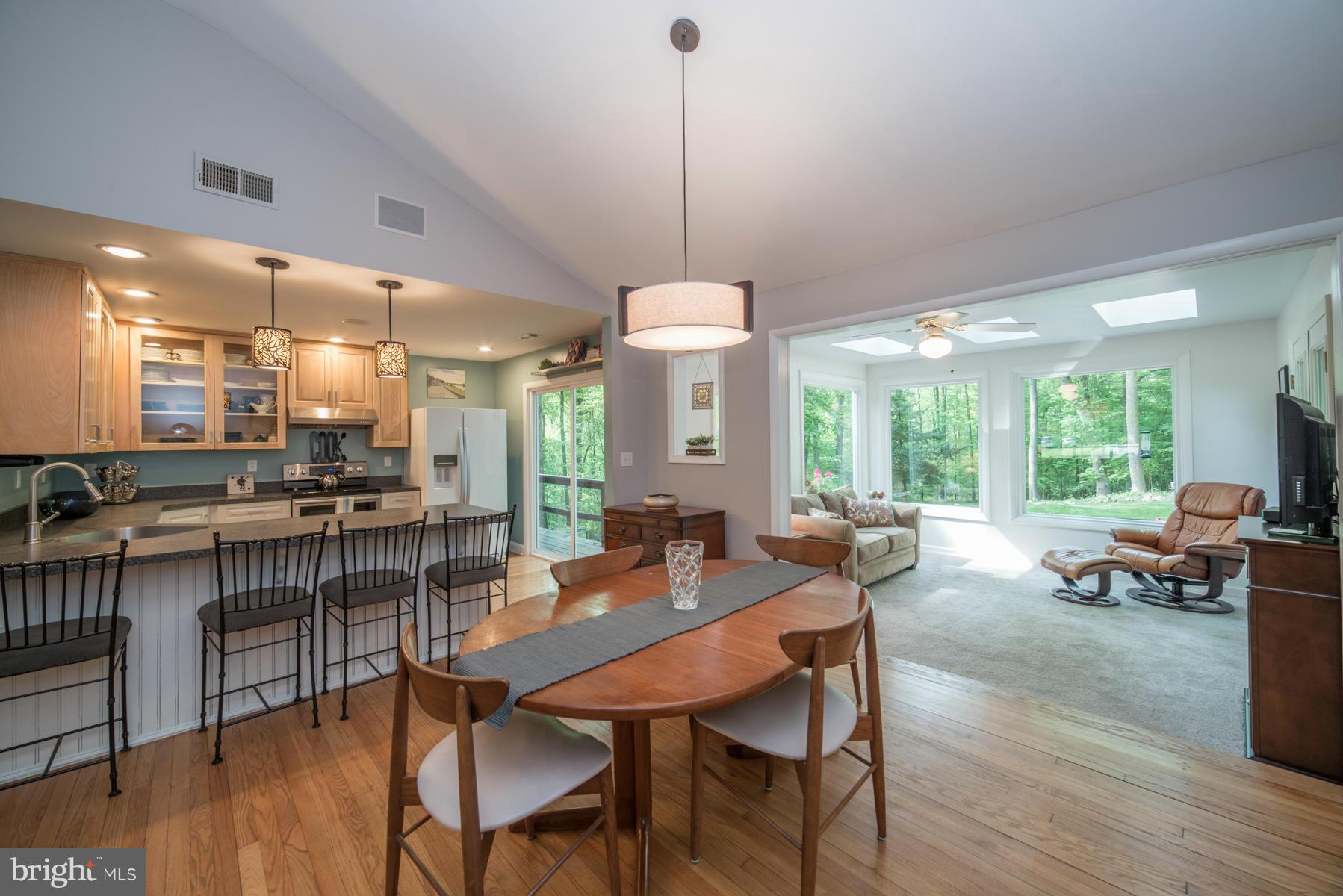 Dining area adjoins kitchen and sunroom