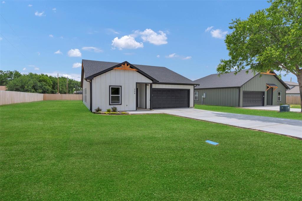 a front view of house with yard and green space
