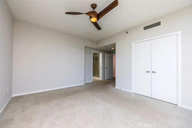 a view of empty room with ceiling fan