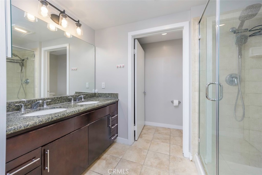411 West Seaside Way, Unit 703 Long Beach, CA 90802 - Photo 23 of 52 a bathroom with a granite countertop sink and a mirror