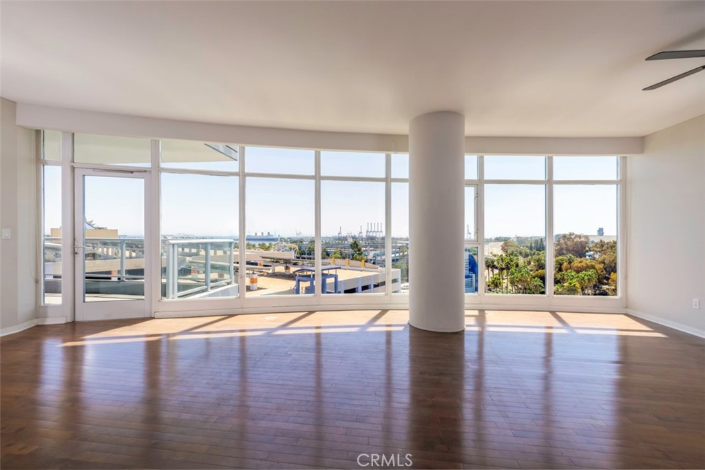 411 West Seaside Way, Unit 703 Long Beach, CA 90802 - Photo 3 of 52 a view of an empty room with wooden floor and a window
