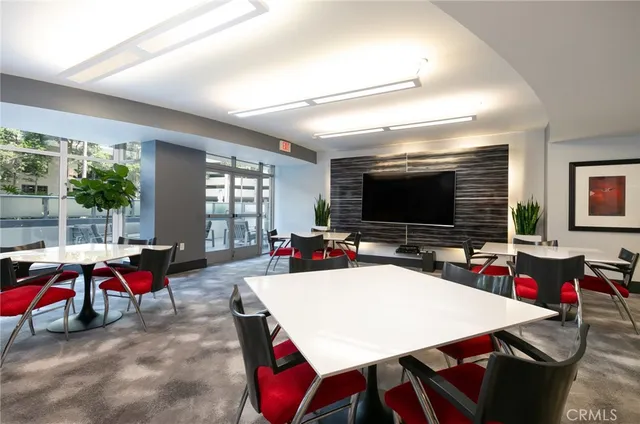 a kitchen with stainless steel appliances a table and chairs in it