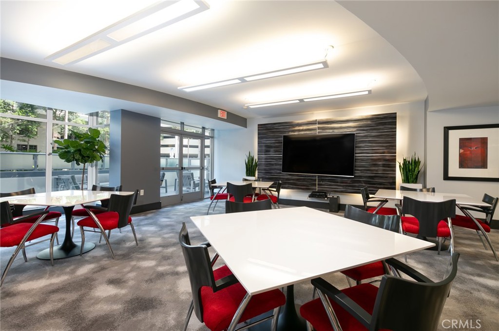 411 West Seaside Way, Unit 703 Long Beach, CA 90802 - Photo 39 of 52 a view of a dining room with furniture and a flat screen tv