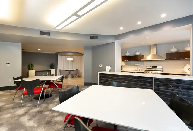 a kitchen with stainless steel appliances granite countertop a sink a stove and a refrigerator