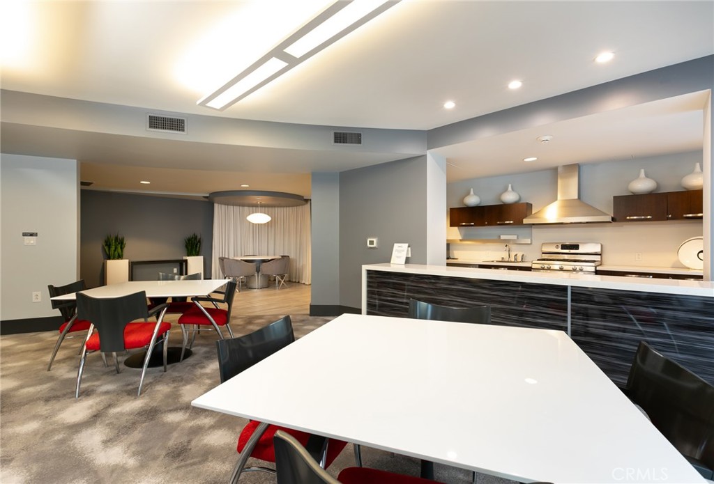 411 West Seaside Way, Unit 703 Long Beach, CA 90802 - Photo 40 of 52 a large kitchen with a table and chairs