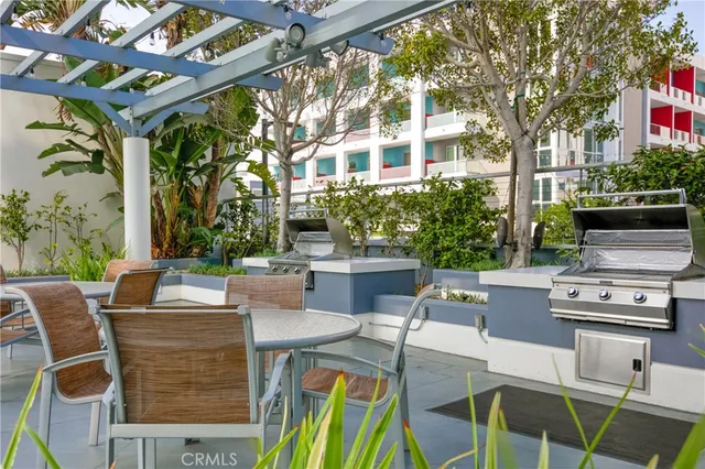 a view of a patio with table and chairs and potted plants