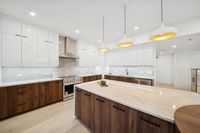 a kitchen with stainless steel appliances granite countertop a sink a counter space and cabinets