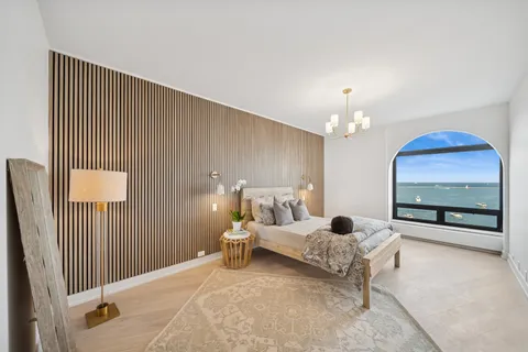 a bedroom with furniture and a chandelier