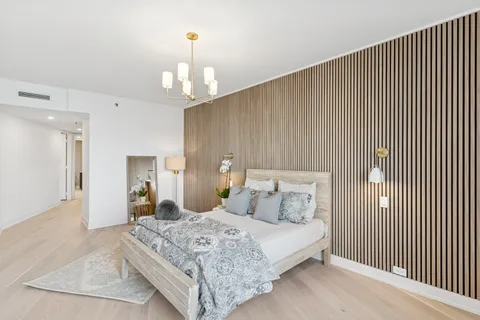 a bedroom with a bed and a chandelier