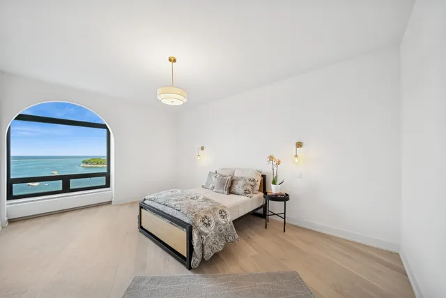 a bedroom with a bed and a balcony view