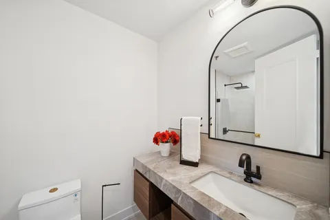 a bathroom with a sink vanity and mirror