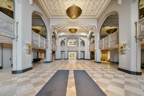a view of living room kitchen with furniture and fireplace