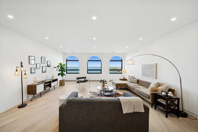 a living room with fireplace furniture and a wooden floor