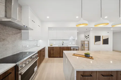 a kitchen with a sink a stove and cabinets